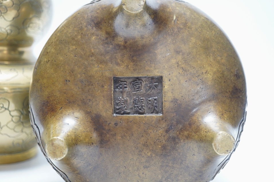A Chinese bronze tripod censer and a similar double gourd vase, 21cm. Condition - poor to fair, vase has obvious repair to body